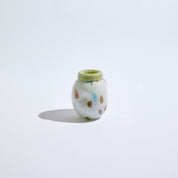 Small lime glass vase with rounded form and hand-applied color bursts