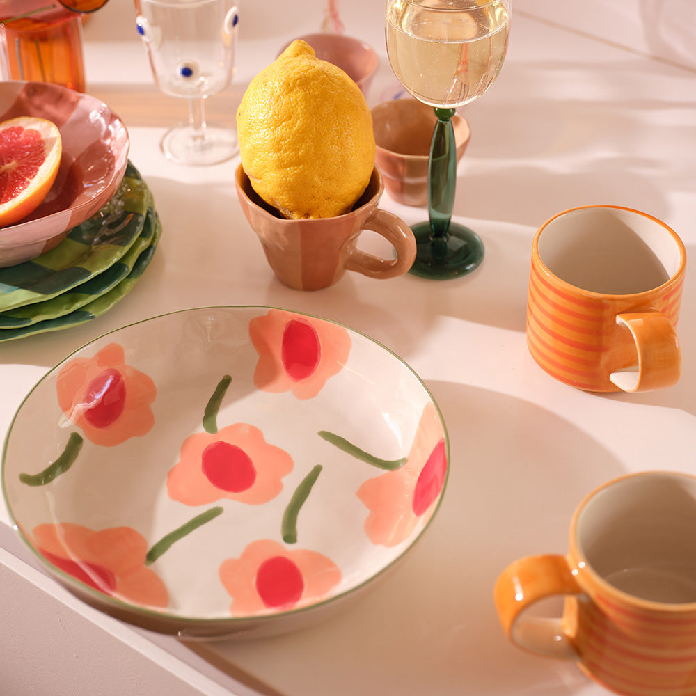 Fleur Bowl Multi on kitchen table, orange blooms visible, frontal view